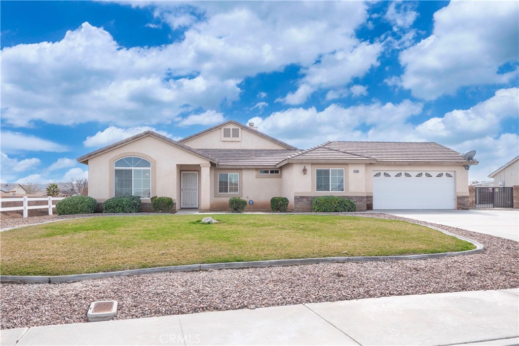 21189 Colombard Way Apple Valley, CA 92308 - Photo 36 of 48 a front view of a house with a garden