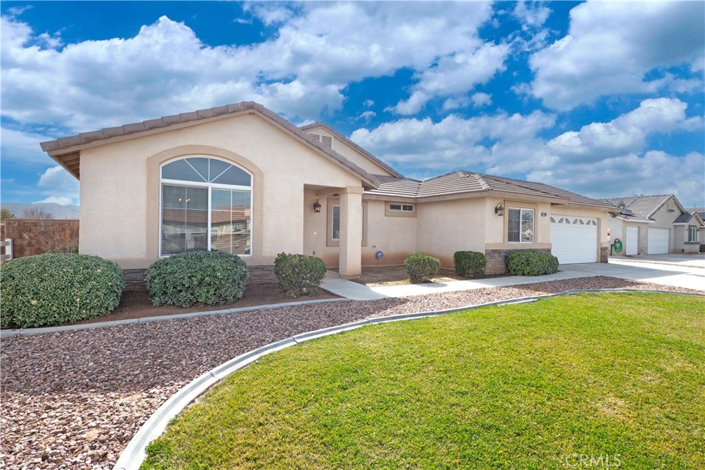 21189 Colombard Way Apple Valley, CA 92308 - Photo 37 of 48 a front view of a house with a yard and garage