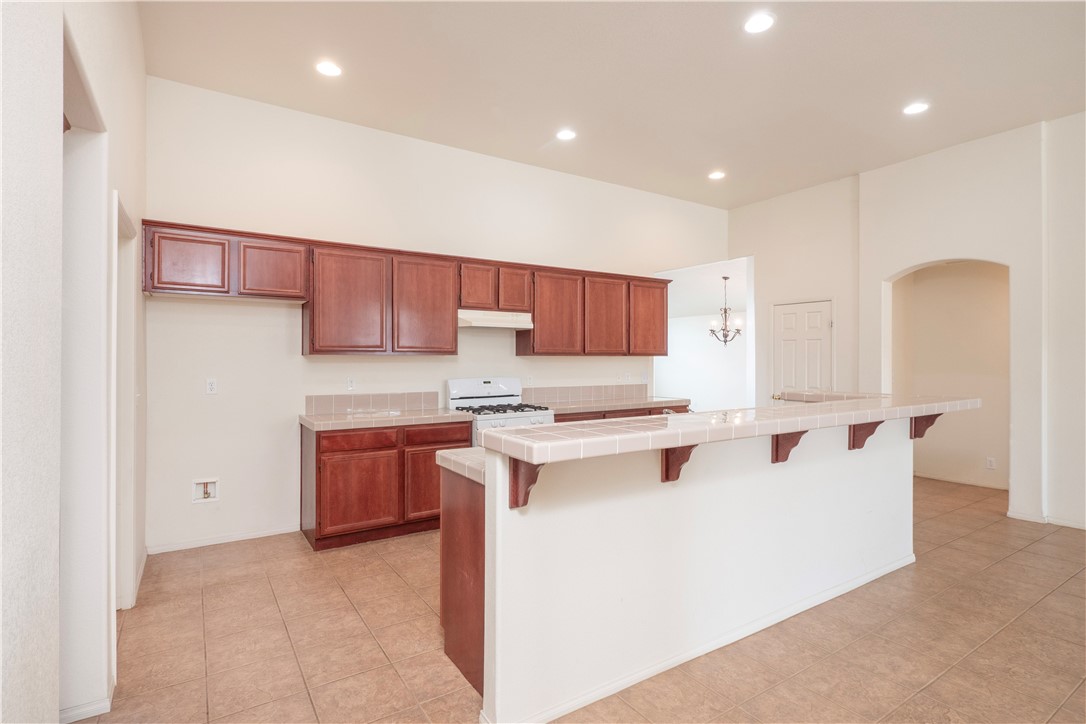 21189 Colombard Way Apple Valley, CA 92308 - Photo 5 of 48 a kitchen with stainless steel appliances a stove a sink and a refrigerator