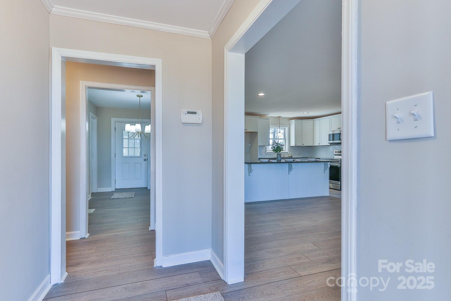 3424 Walker Circle Lenoir, NC 28645 - Photo 13 of 38 a view of a hallway with wooden floor and a kitchen