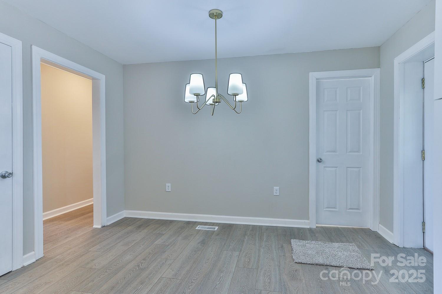 3424 Walker Circle Lenoir, NC 28645 - Photo 16 of 38 an empty room with wooden floor and windows