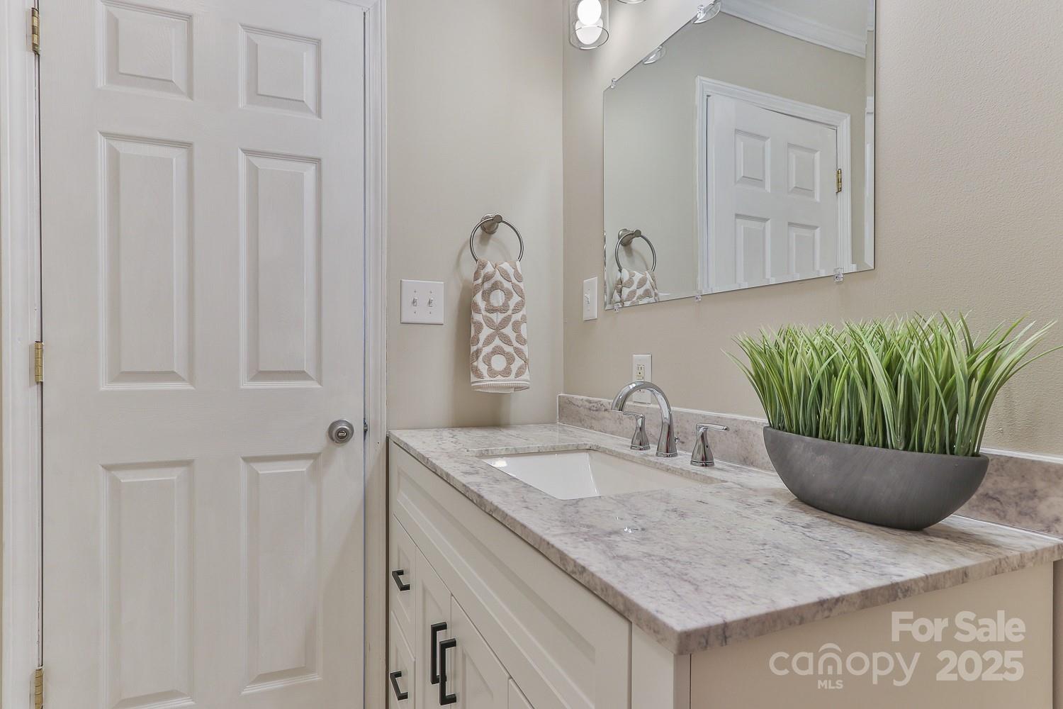 3424 Walker Circle Lenoir, NC 28645 - Photo 28 of 38 a bathroom with a granite countertop sink and a mirror