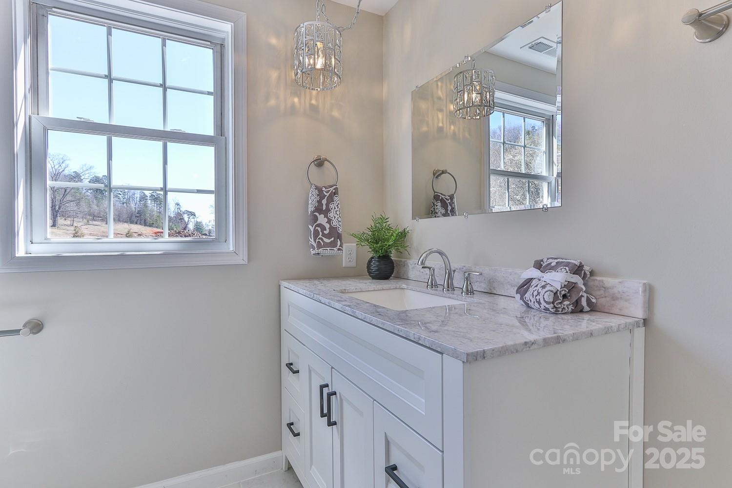 3424 Walker Circle Lenoir, NC 28645 - Photo 32 of 38 a bathroom with a granite countertop sink and a mirror