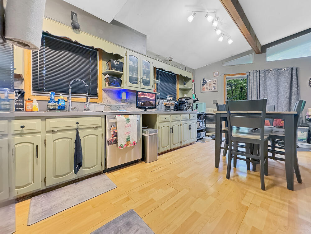 163 Granite Road Long Pond, PA 18334 - Photo 7 of 19 a kitchen with stainless steel appliances granite countertop a table chairs sink and cabinets