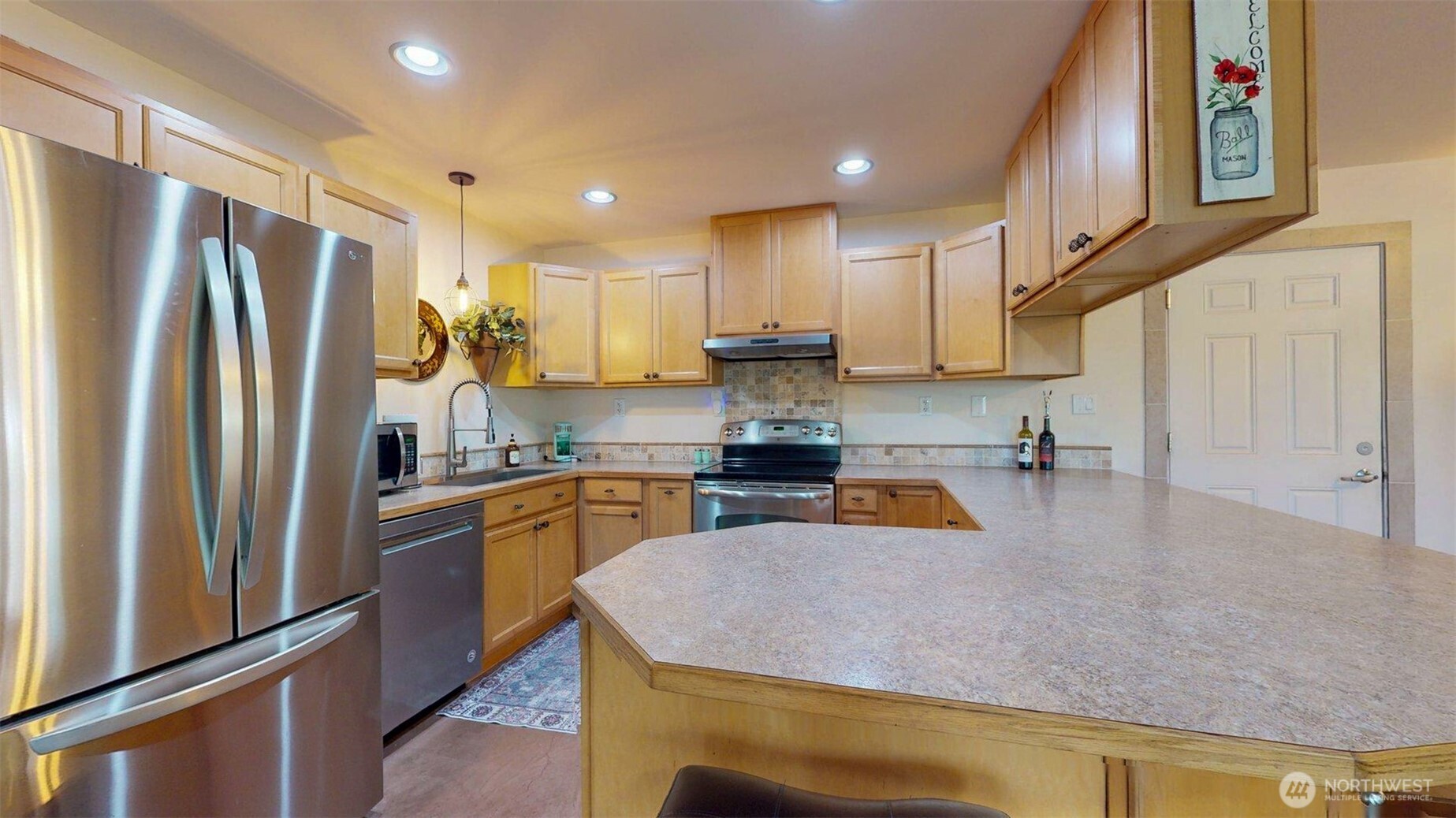 46 Shumway Road Omak, WA 98841 - Photo 14 of 40 a kitchen with stainless steel appliances granite countertop a refrigerator a sink and a stove