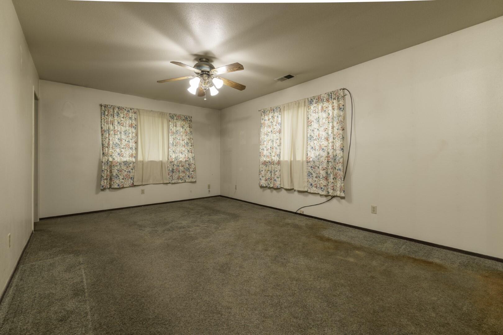3305 Cessna Drive Redding, CA 96001 - Photo 12 of 15 an empty room with windows and chandelier fan