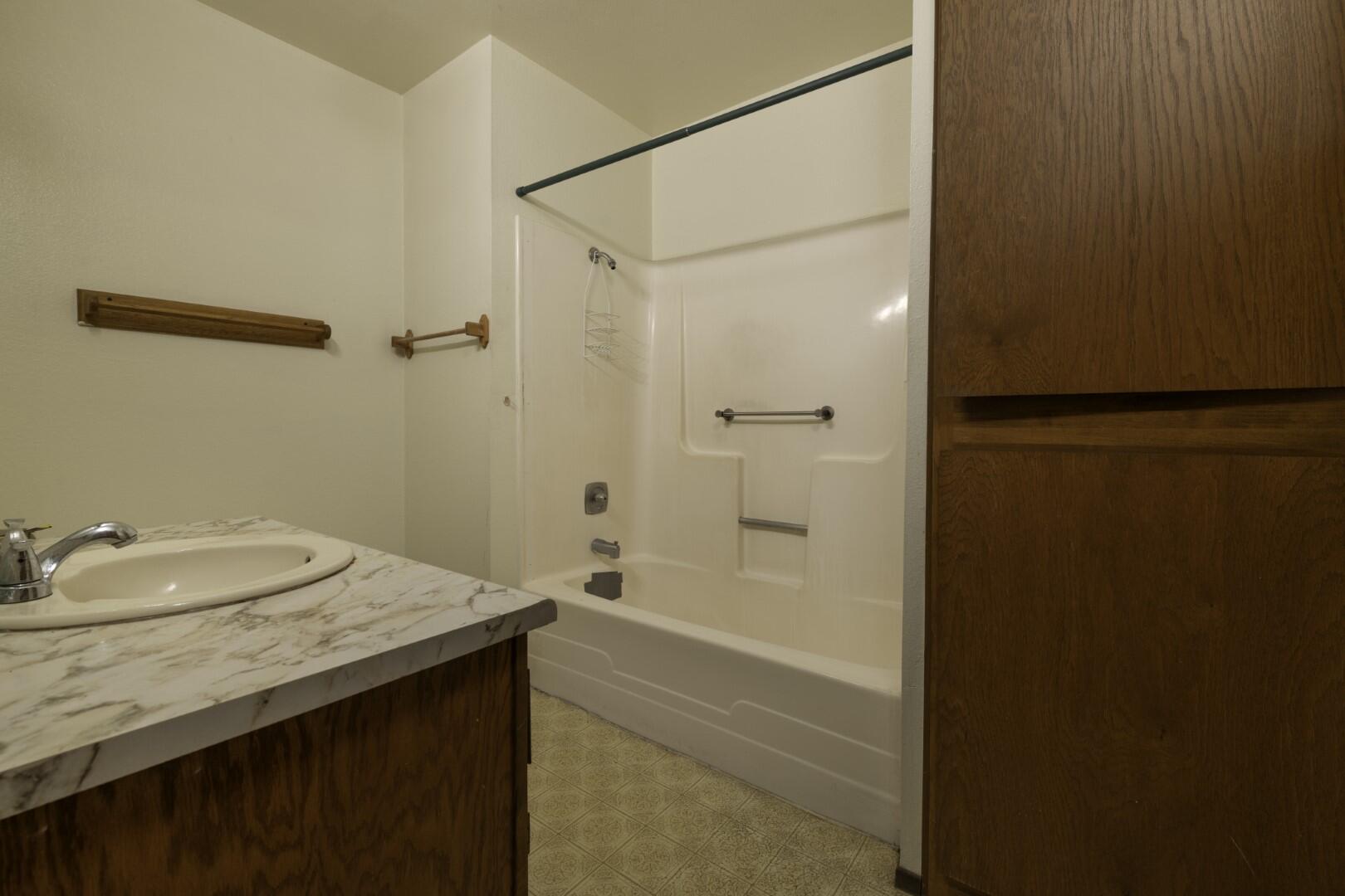 3305 Cessna Drive Redding, CA 96001 - Photo 14 of 15 a bathroom with a granite countertop sink and a mirror