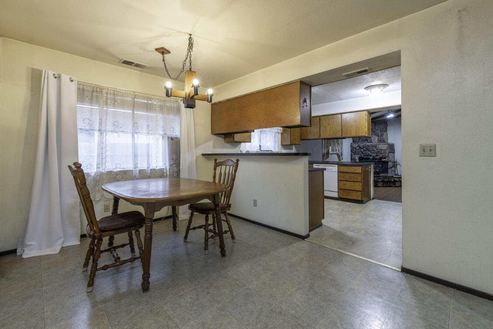 3305 Cessna Drive Redding, CA 96001 - Photo 6 of 15 a kitchen with a table and chairs in it