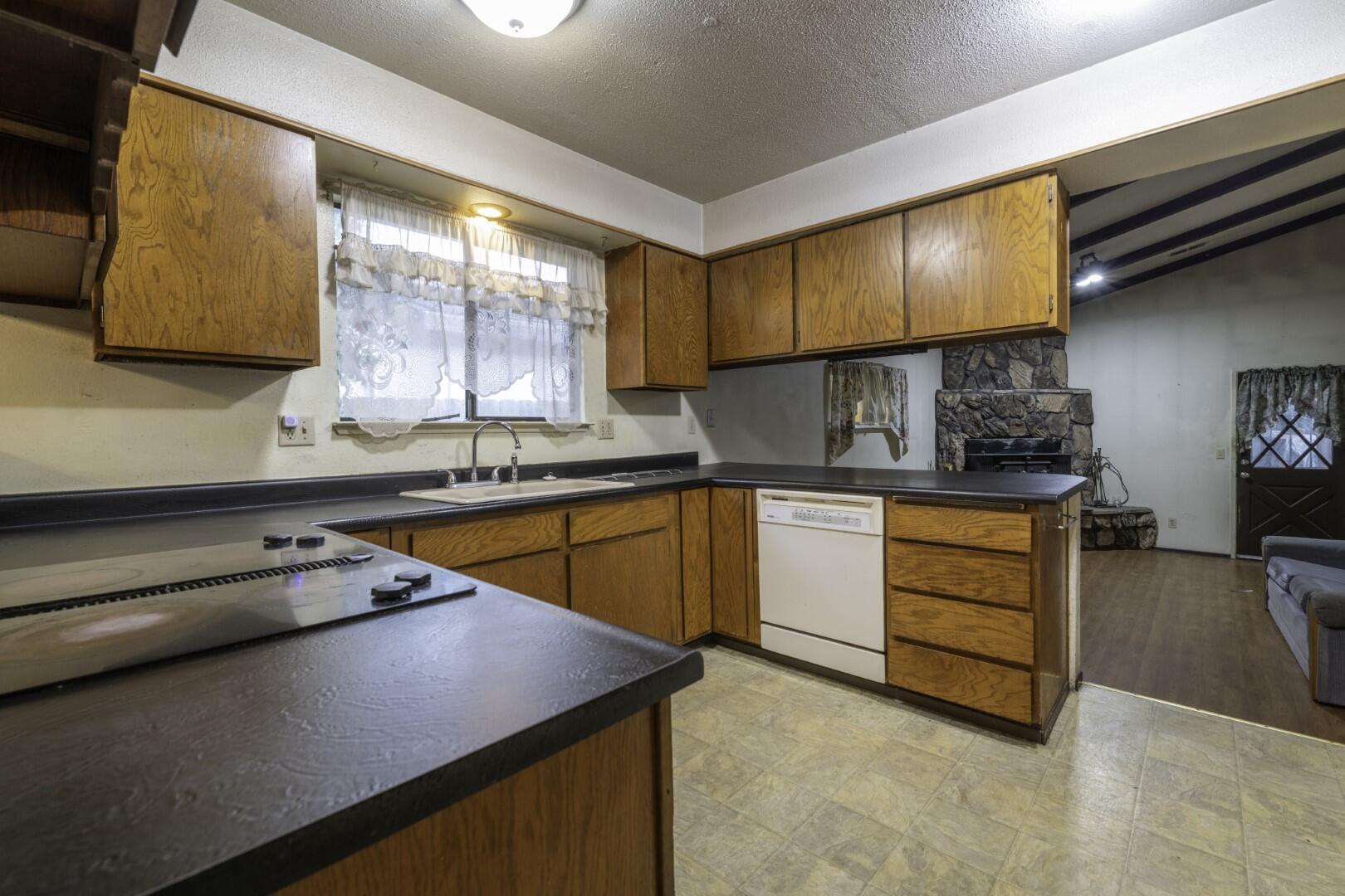 3305 Cessna Drive Redding, CA 96001 - Photo 7 of 15 a kitchen with stainless steel appliances granite countertop a sink a stove and a refrigerator