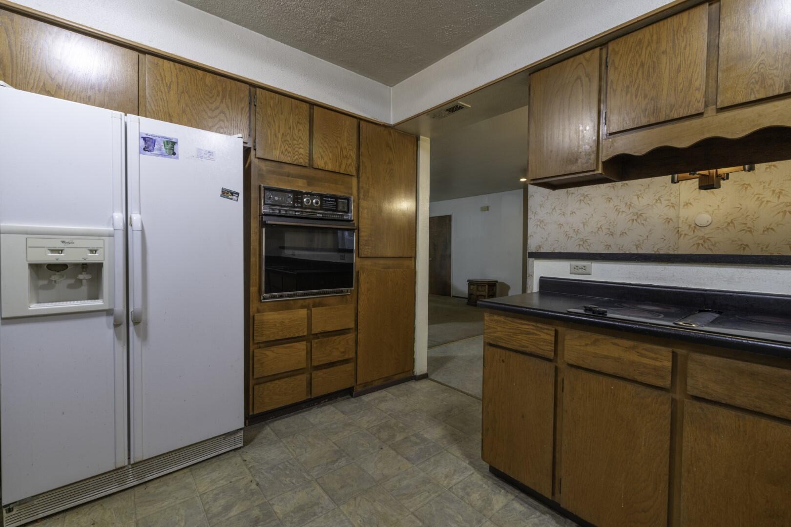3305 Cessna Drive Redding, CA 96001 - Photo 8 of 15 a kitchen with stainless steel appliances granite countertop a refrigerator and a sink