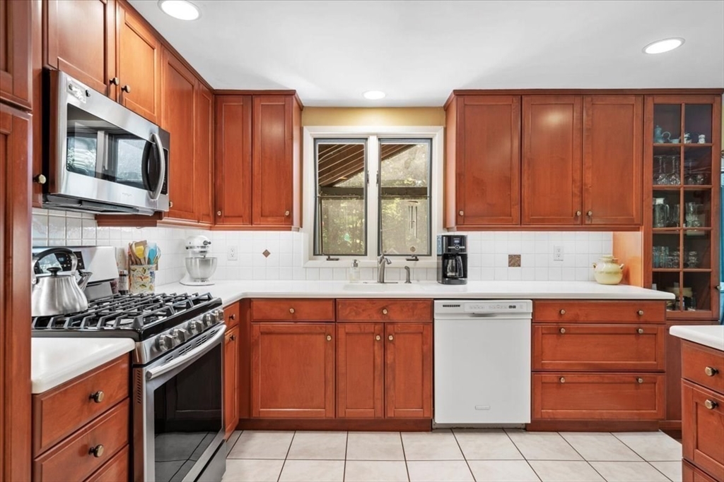 31 Lawton Road Shirley, MA 01464 - Photo 7 of 37 a kitchen with stainless steel appliances granite countertop a stove top oven a sink dishwasher and cabinets with wooden floor