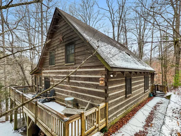 a view of a house with a wooden deck