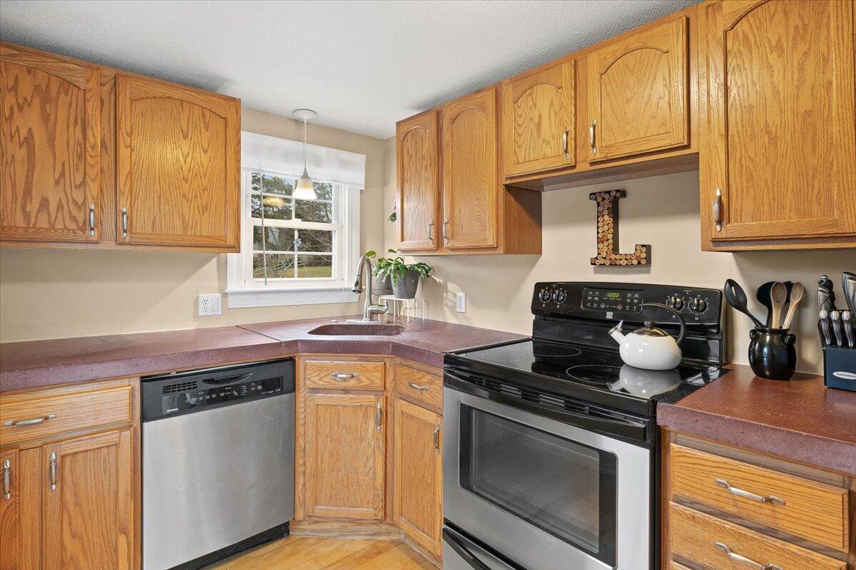 24 Regency Drive Sagamore, MA 02561 - Photo 11 of 27 a kitchen with stainless steel appliances granite countertop a stove and a sink