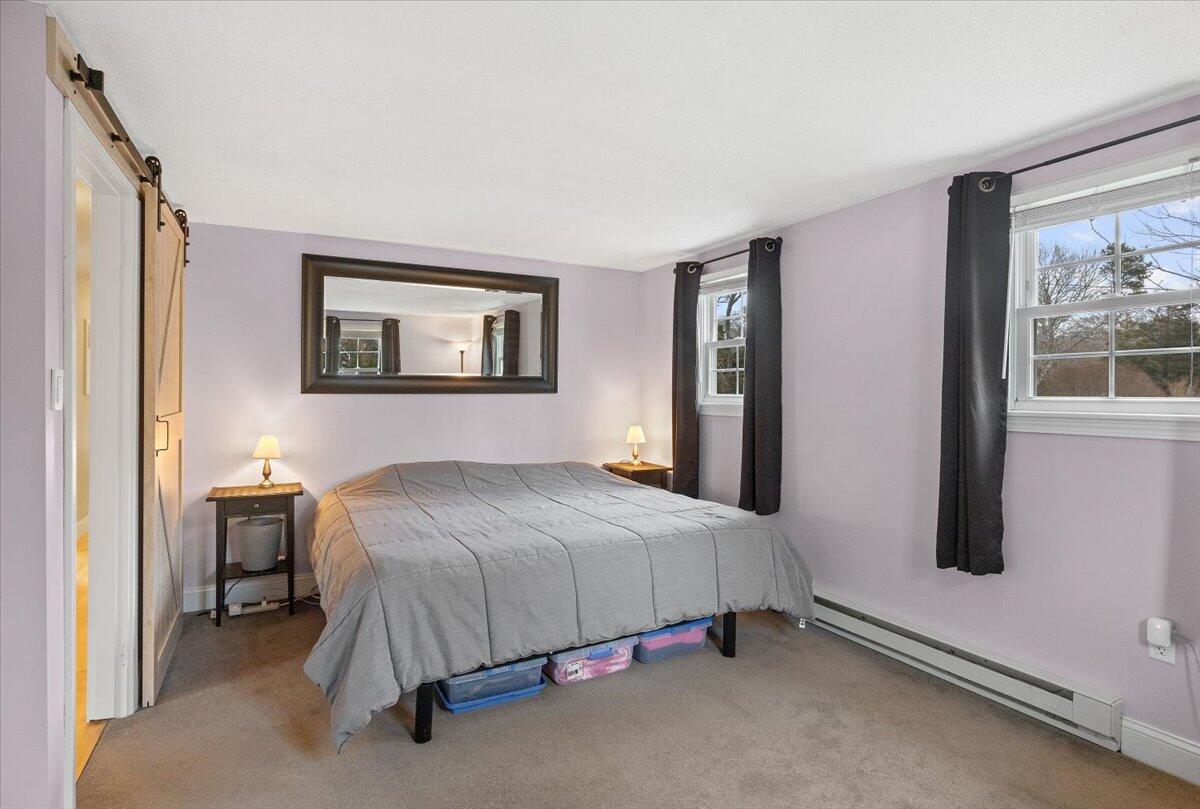 24 Regency Drive Sagamore, MA 02561 - Photo 13 of 27 a bedroom with a bed and window