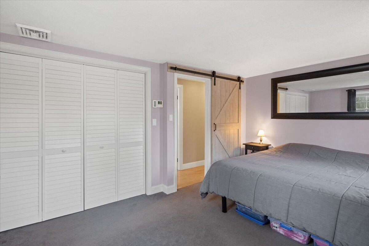 24 Regency Drive Sagamore, MA 02561 - Photo 14 of 27 a bedroom with a bed and a cabinets