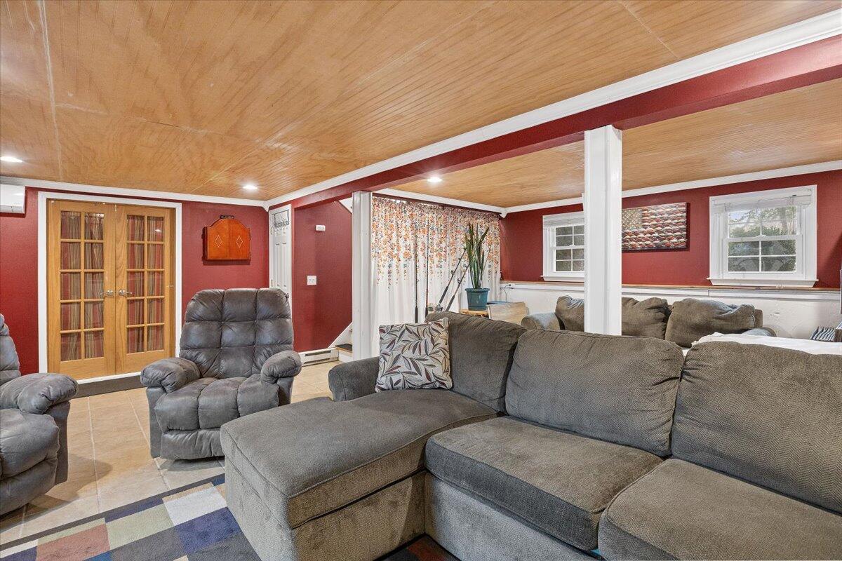 24 Regency Drive Sagamore, MA 02561 - Photo 18 of 27 a living room with furniture and large windows