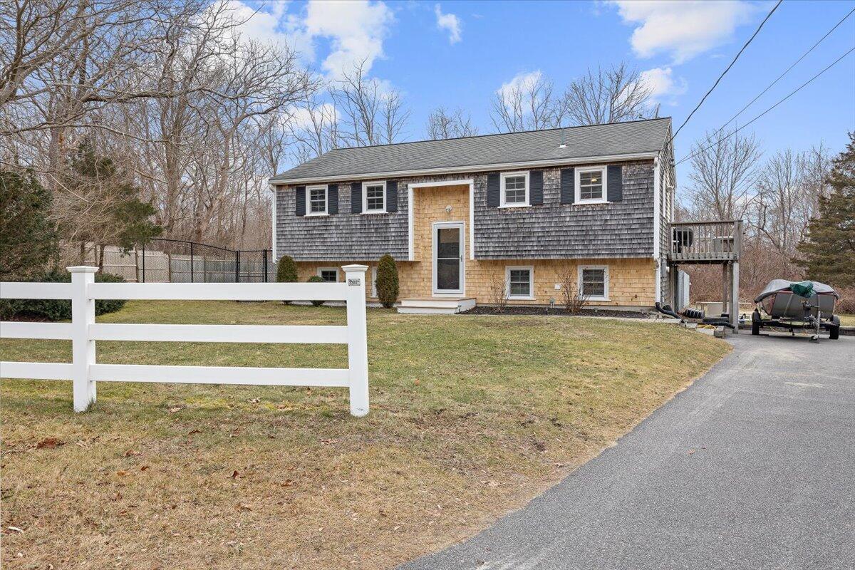24 Regency Drive Sagamore, MA 02561 - Photo 2 of 27 a front view of a house with a yard