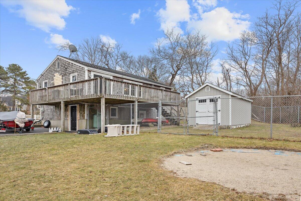 24 Regency Drive Sagamore, MA 02561 - Photo 21 of 27 a front view of a house with a garden and trees