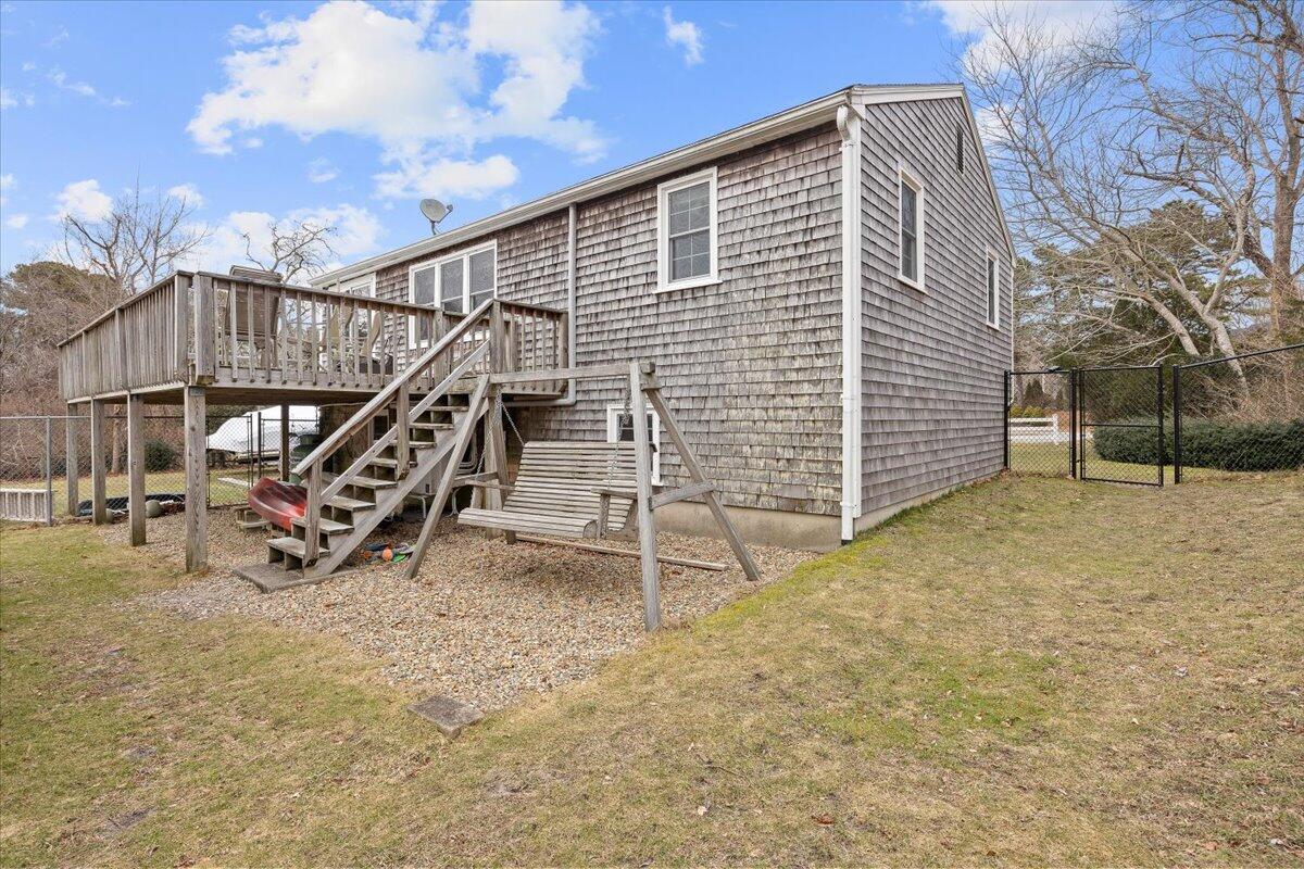 24 Regency Drive Sagamore, MA 02561 - Photo 22 of 27 a view of a house with a wooden fence