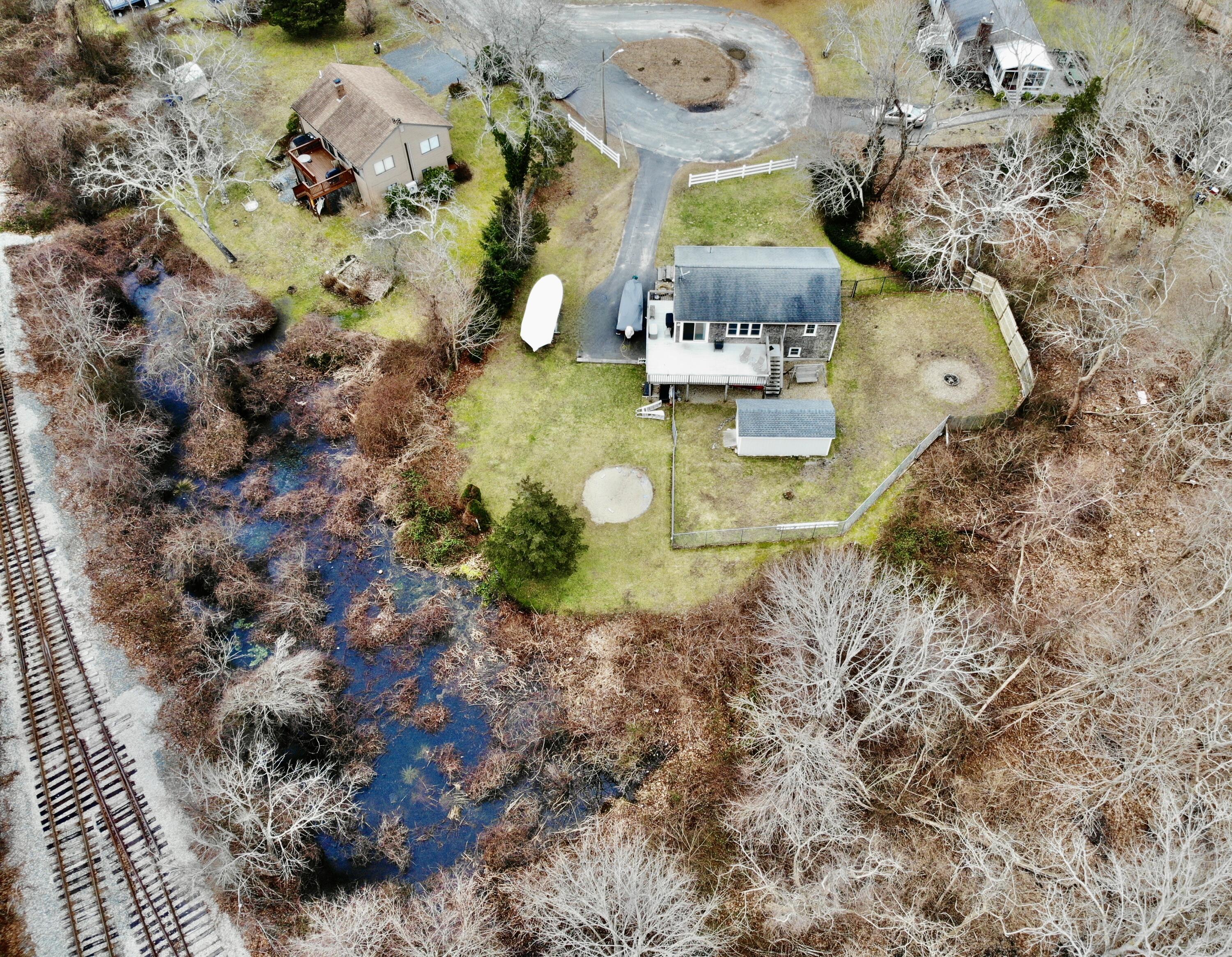 24 Regency Drive Sagamore, MA 02561 - Photo 25 of 27 a aerial view of a house with a yard and sitting area