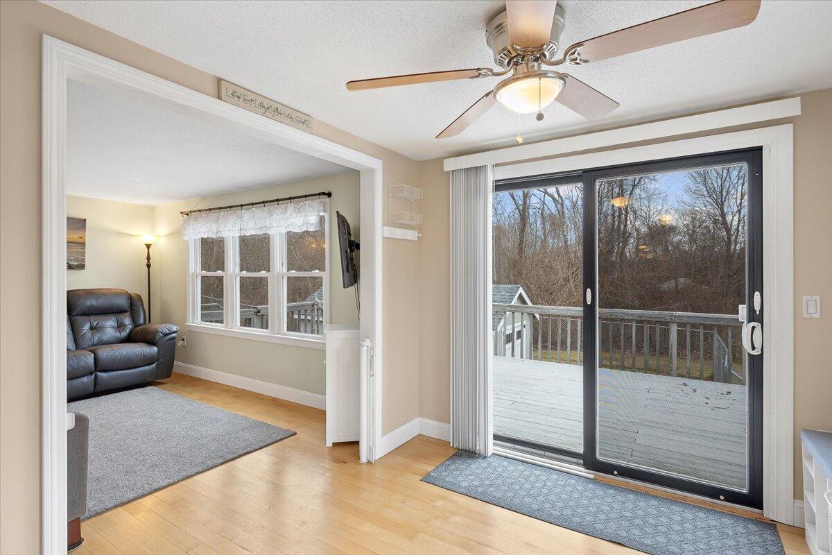 24 Regency Drive Sagamore, MA 02561 - Photo 7 of 27 a living room with a large window and chandelier