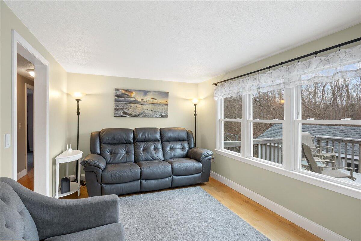 24 Regency Drive Sagamore, MA 02561 - Photo 8 of 27 a living room with furniture and a large window