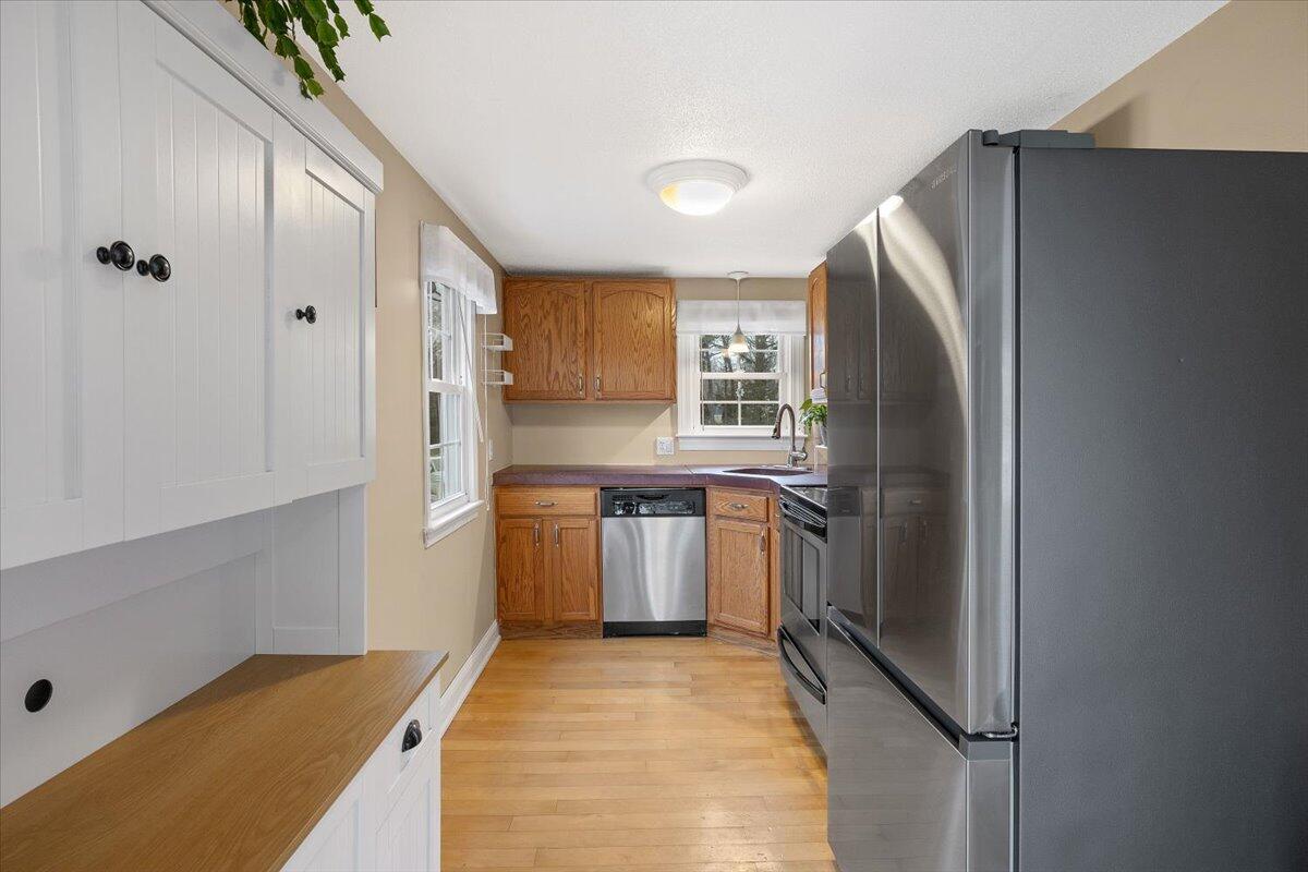 24 Regency Drive Sagamore, MA 02561 - Photo 10 of 27 a kitchen with a refrigerator and a sink