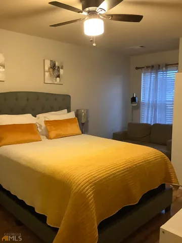 a bathroom with a sink a toilet a mirror and shower curtain