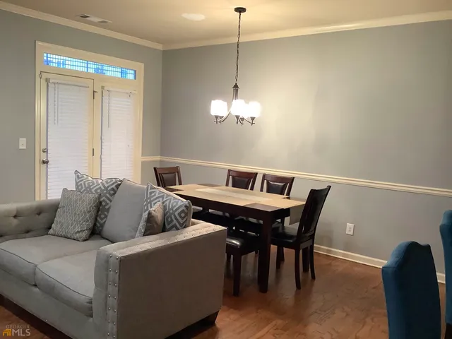 a living room with furniture and a chandelier