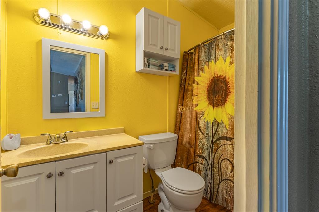 75 Southern Road Mineral Wells, TX 76067 - Photo 25 of 31 a bathroom with a granite countertop sink toilet and shower