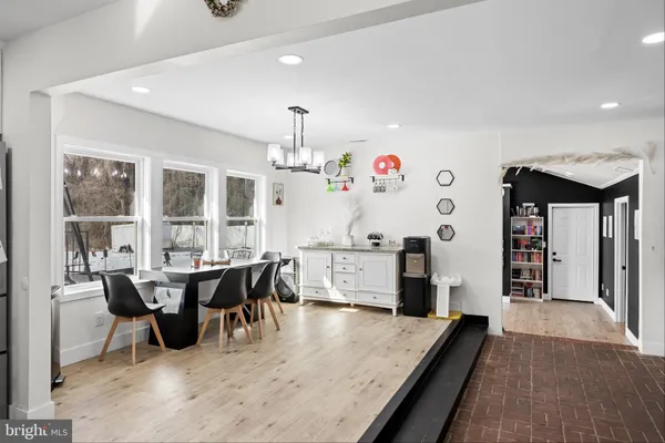 a living room with furniture and a dining table with kitchen view