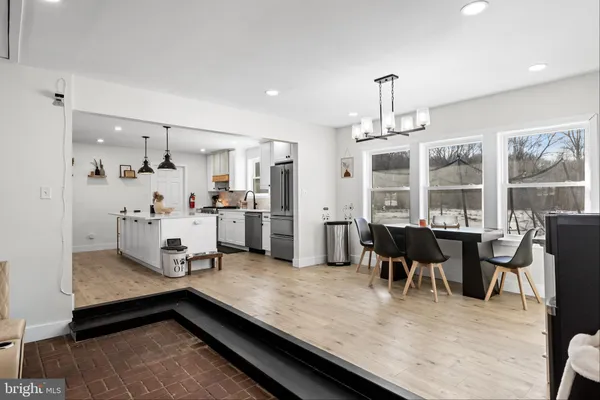 a living room with stainless steel appliances kitchen island granite countertop furniture and a kitchen view