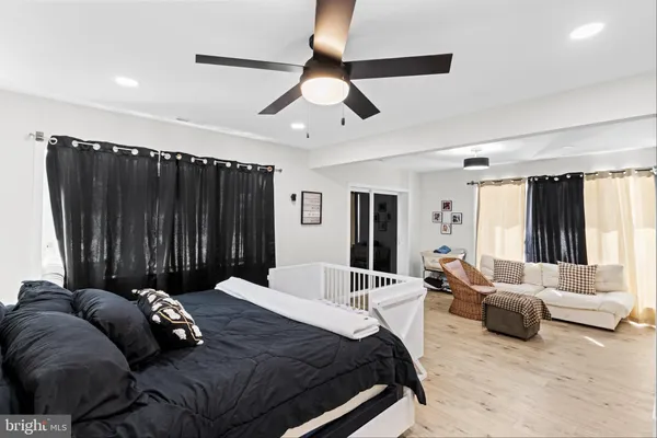 a bedroom with a bed couch and window