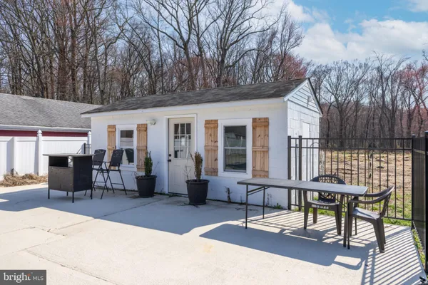 a backyard of a house with table and chairs