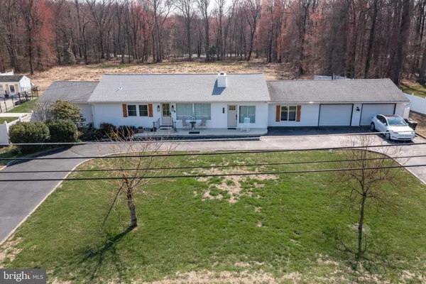 a view of a house with pool and a yard