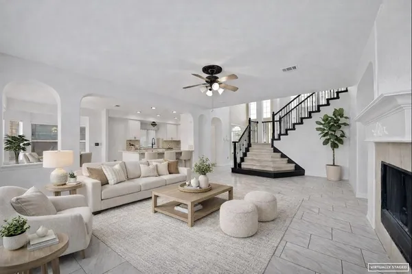 a living room with furniture and a chandelier