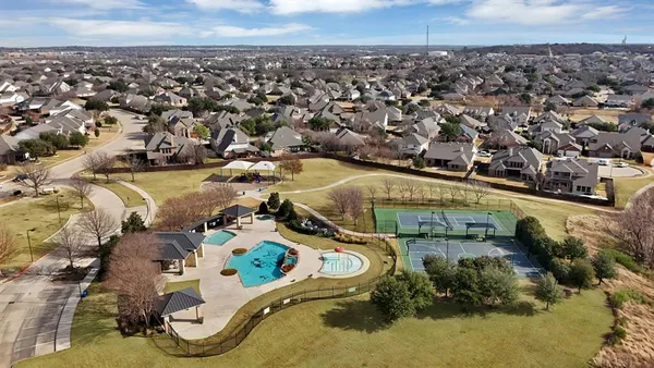 an aerial view of residential houses with outdoor space