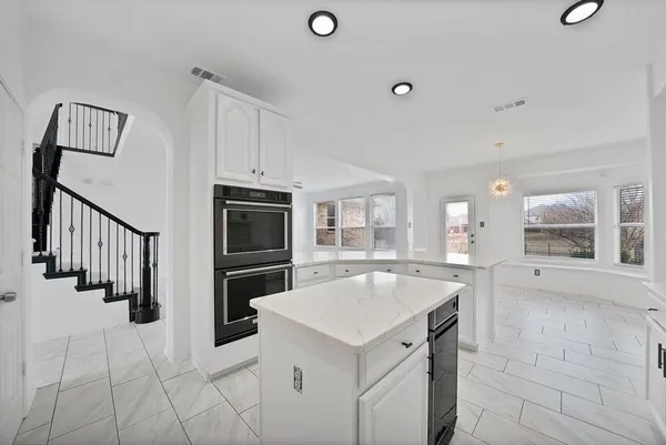 a kitchen with a stove a refrigerator and a sink