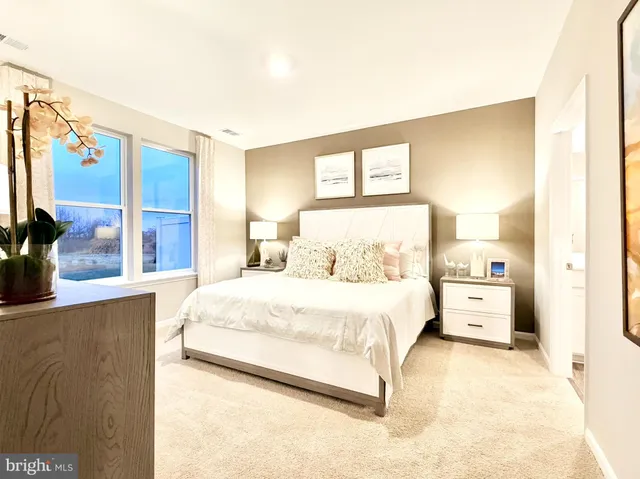 a large white bed in a white room