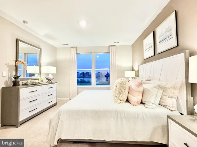 a bedroom with a large bed and a dresser