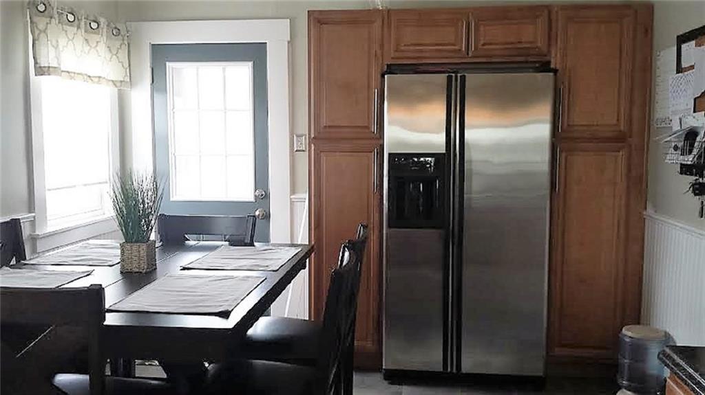 443 Routh Street Monroeville, PA 15146 - Photo 7 of 13 Built-in "twin" pantry cabinets flank the stainless refrigerator to provide ample storage space for cooking accessories and/or caned goods. Access to the rear porch and fenced-in backyard is through the door seen here.