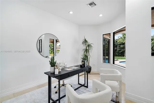 a living room with furniture and a potted plant