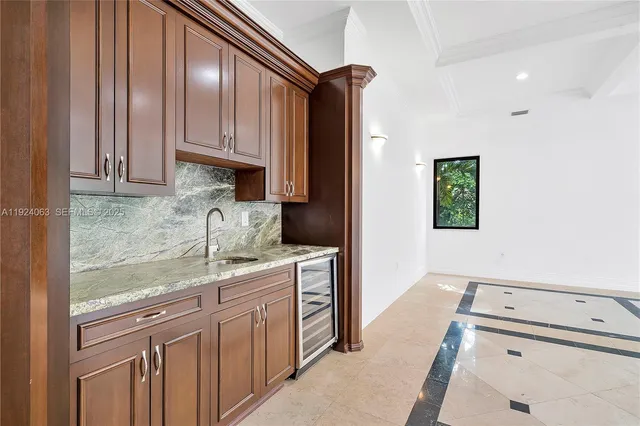 a kitchen with kitchen island granite countertop a sink stove and cabinets