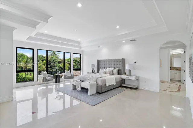 a bed room with a bed and a large window