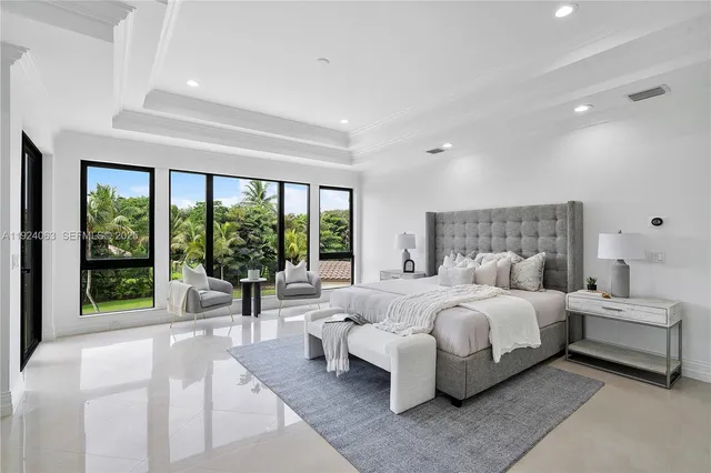 a bedroom with a large bed and a large window