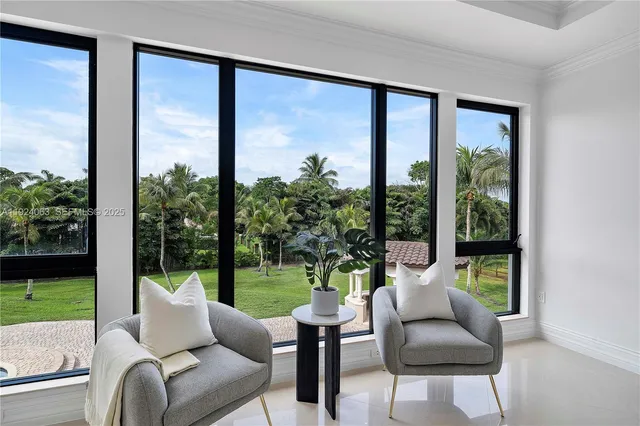 a living room with couch and a view of a garden