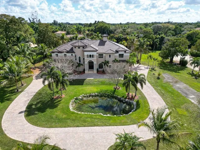 a aerial view of a house with a garden and trees