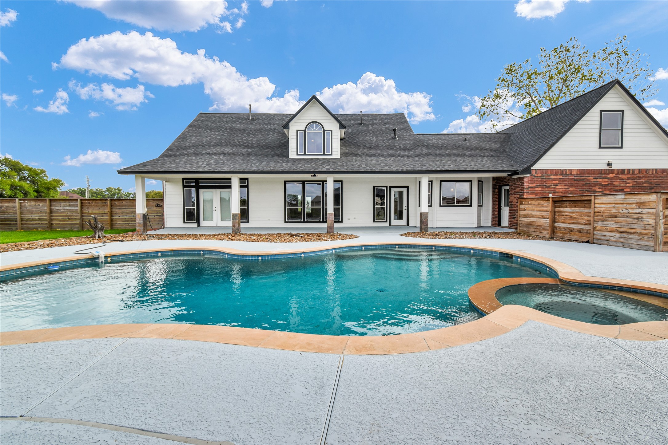 863 Bunkhouse Trail Angleton, TX 77515 - Photo 17 of 22 This photo showcases a spacious backyard. The area is enclosed by a wooden fence, offering privacy and a serene atmosphere.