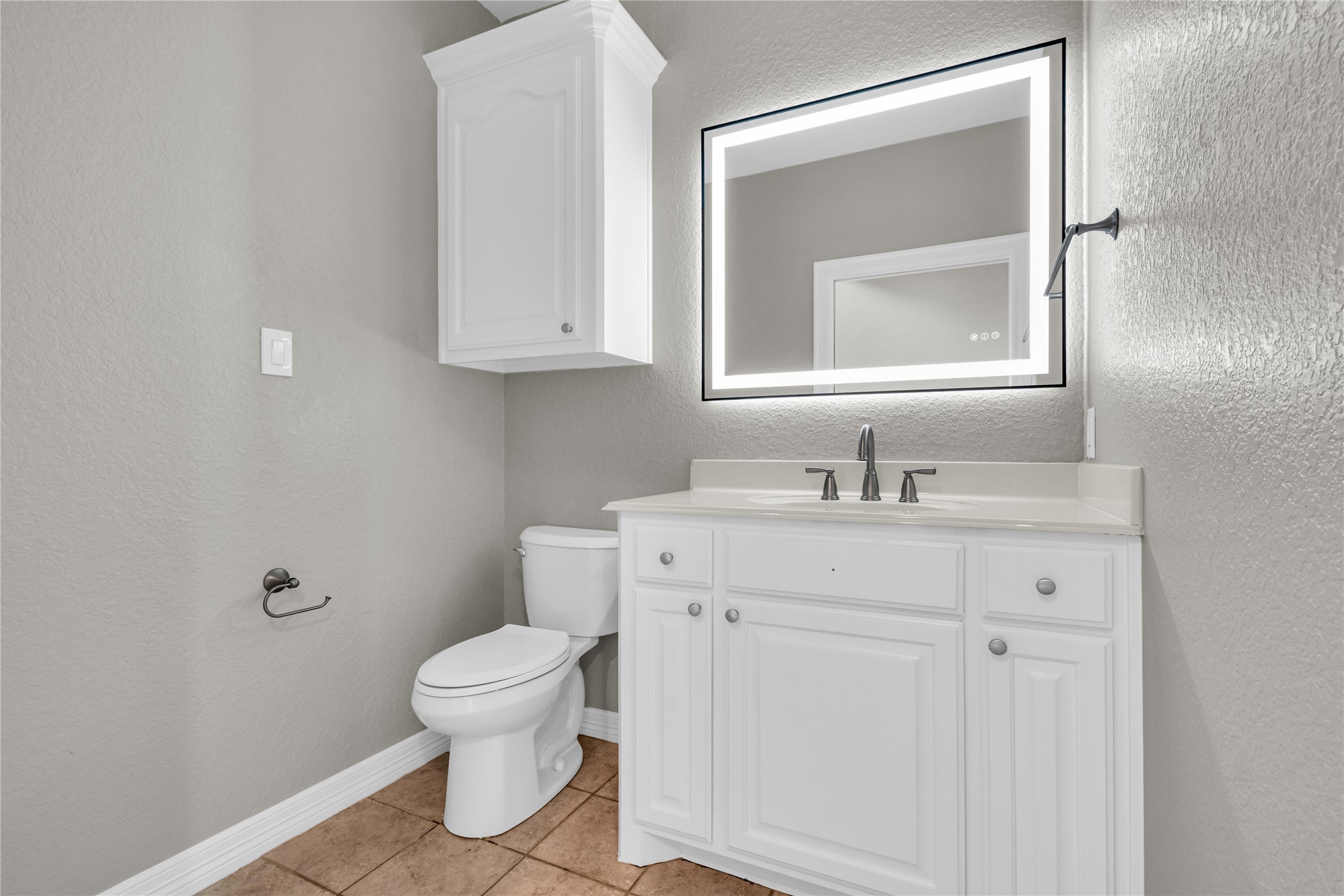 863 Bunkhouse Trail Angleton, TX 77515 - Photo 3 of 22 Half bath on first floor with an illuminated mirror.