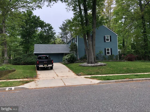 a view of a house with a yard and tree s